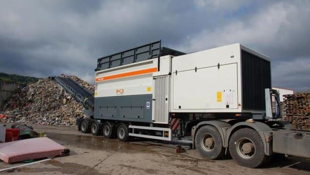 Trailer-mounted shredder at a waste transfer station